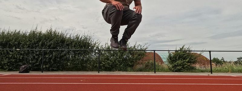 Dynamic silhouette of a man jumping during training